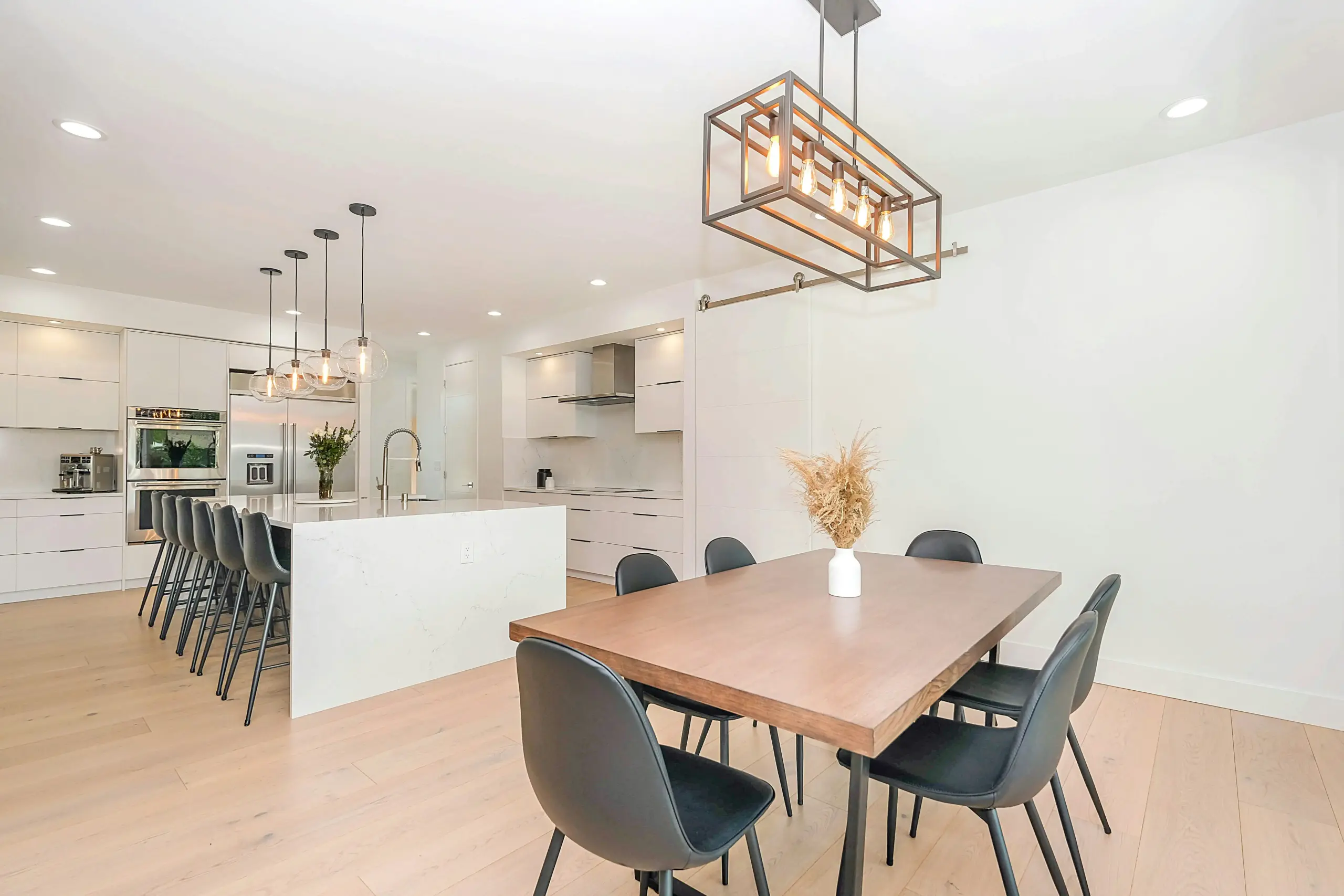 Professionally staged kitchen and dining area with modern furnishings, showcasing traditional home staging techniques for real estate listing marketing..