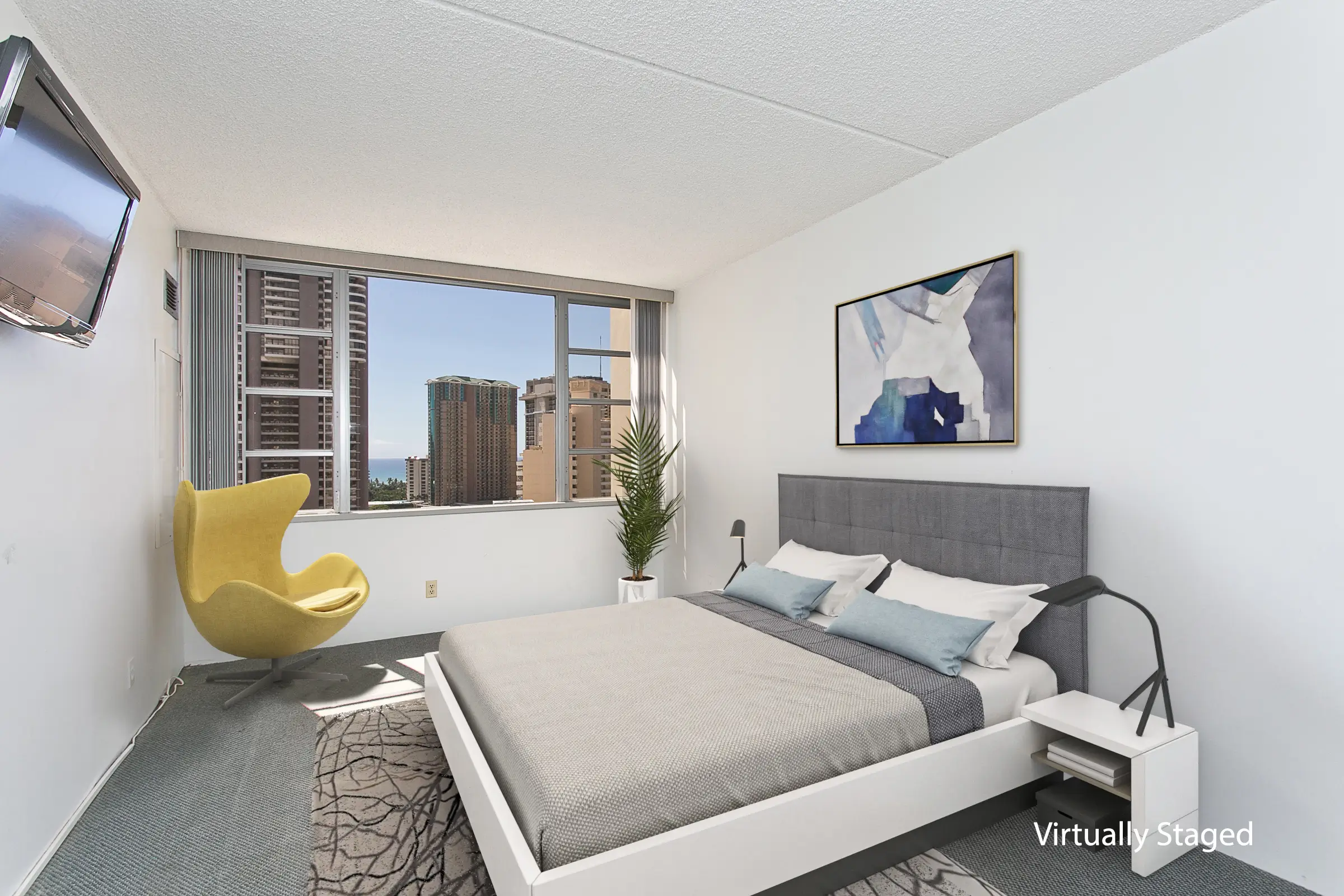 An image of a virtually staged apartment bedroom in a neutral color palette with an accent yellow armchair