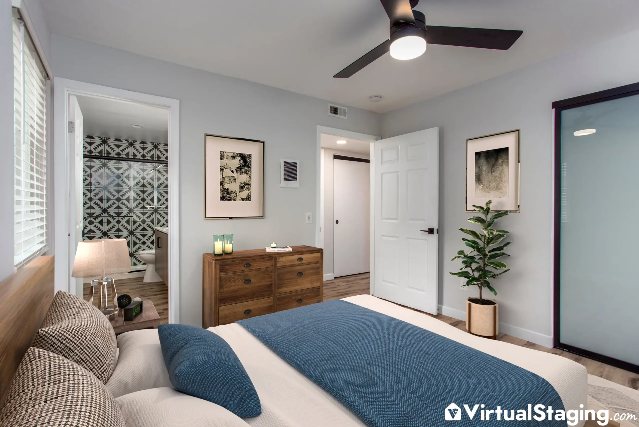 A master bedroom that's been virtually staged neutrally with pops of blue color